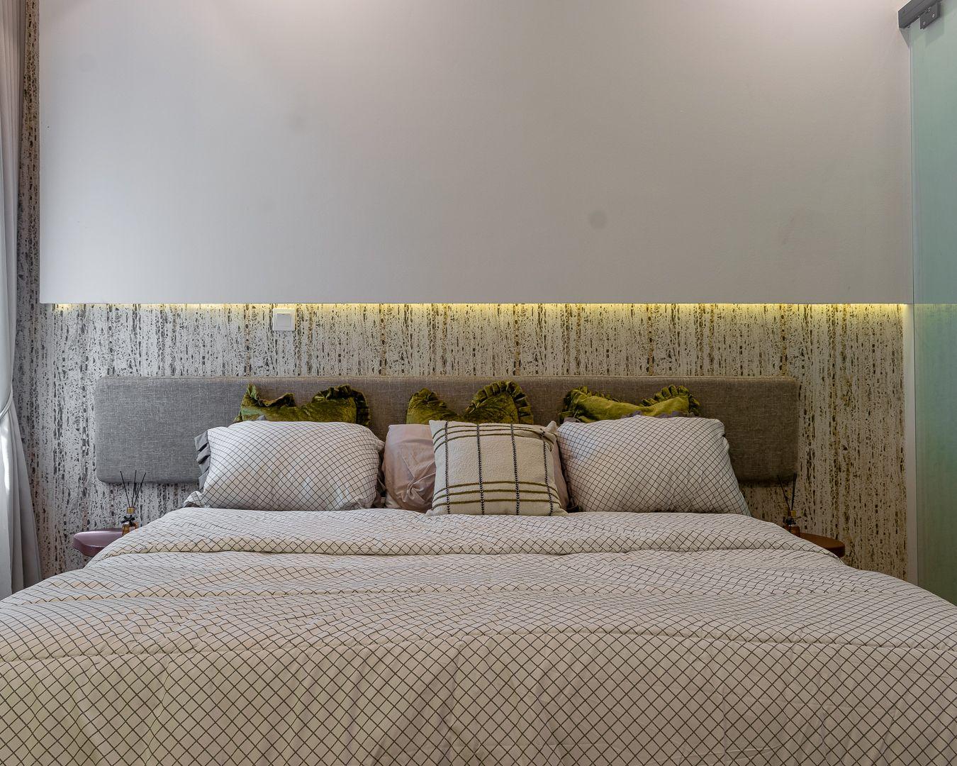 Guest bedroom with a grey upholstered headboard against cork textured wallcovering