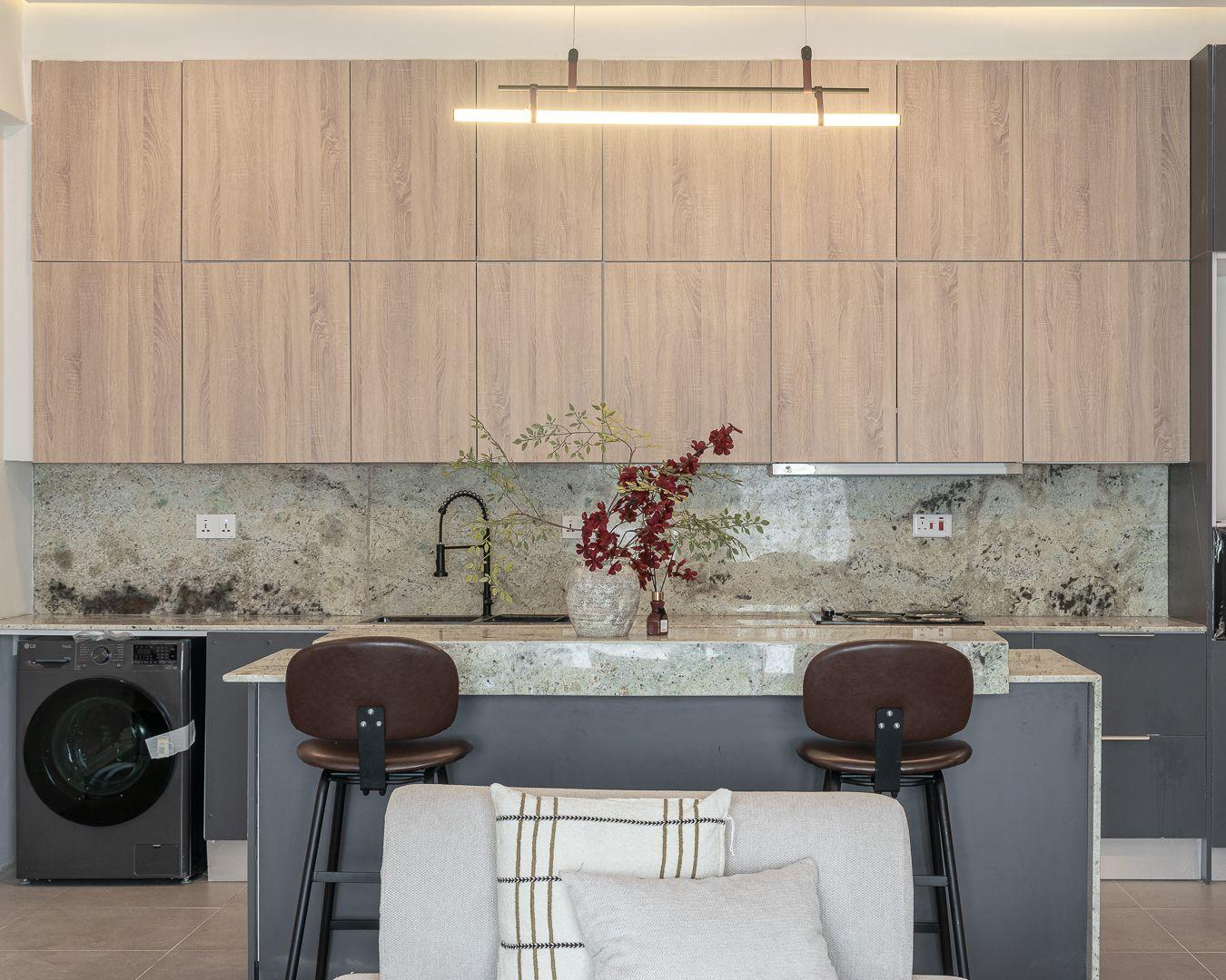 Kitchen with smoked oak cabinetry, granite island and a linear brass pendant