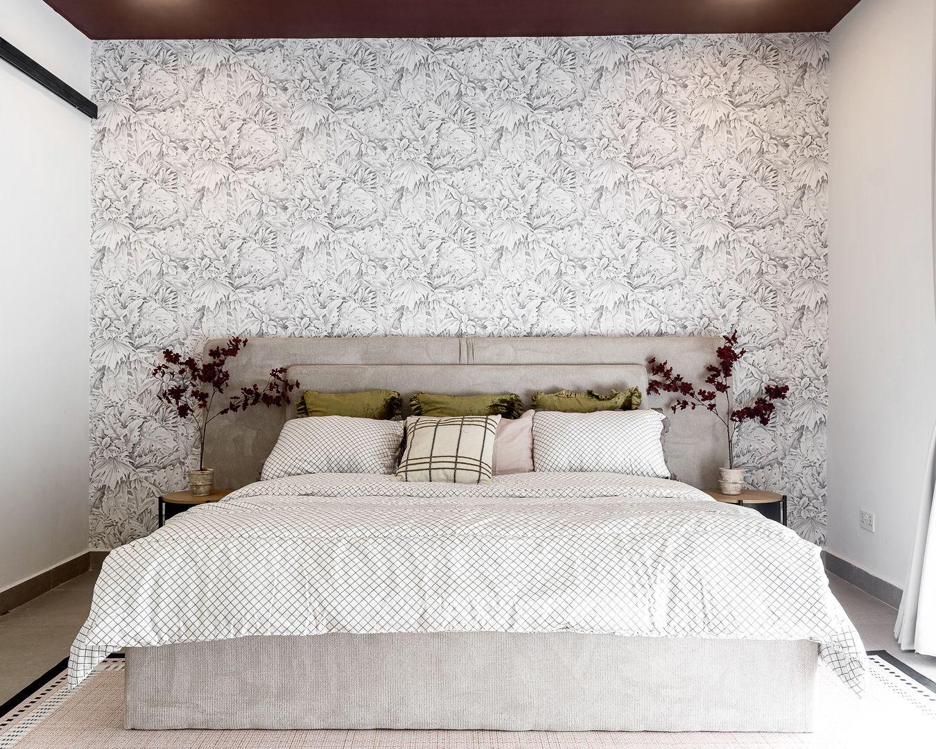 Main bedroom wrapped in palm etched wallpaper beneath a wine painted ceiling