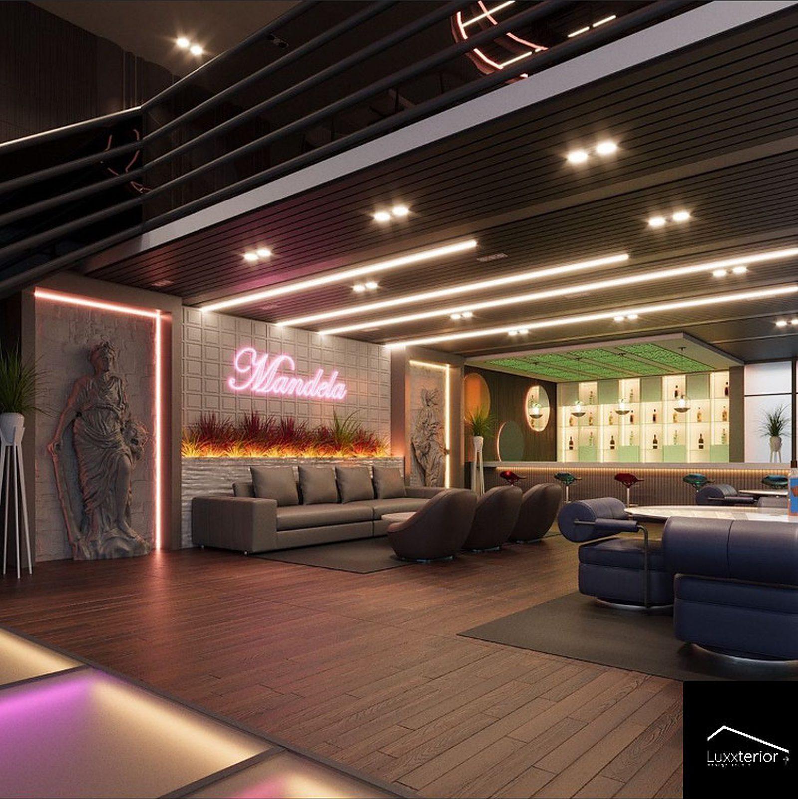 Resto bar lounge with neon signage, a linear fireplace and deep booth seating